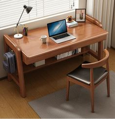 a laptop computer sitting on top of a wooden desk next to a chair and window