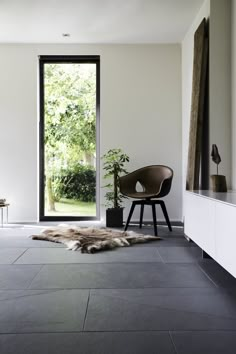 a chair sitting on top of a floor next to a window