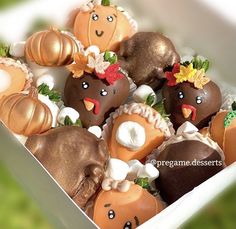 there are many chocolates in the box with decorations on them, and one is decorated like an animal