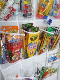 some plastic bags and pencils are hanging on the wall next to other school supplies