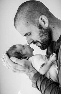 a man holding a baby in his arms