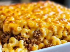 a casserole dish with cheese and ground beef in it on a white plate