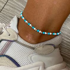 🌸 white, turquoise and silver miracle bead anklet 🌸  ♥️Catches the light to give off a glow!  ♥️Perfect for nights out or even holidays!  ♥️Please message me if you have any questions each  ♥️ All anklets are made on rope. The two ends will need to be tied together and in a double knot so that the anklet does not come off. These are safe to wear in water.  Also available with matching bracelets, earrings and chokers! White beads may appear grey/silver when opened in a dark room. The full effect of the beads will shine through in different lights. Please note: Buyer pays for any return postage/ exchange postage x Adjustable White Anklets With Colorful Beads, White Round Bead Anklets For Summer, White Round Beads Anklet For Summer, White Tiny Beads Anklets For Festival, White Beaded Anklets For Festival, White Beaded Festival Anklets, Colorful Beaded White Anklets As Gift, White Anklets With Colorful Beads As A Gift, White Anklets With Colorful Beads For Gift