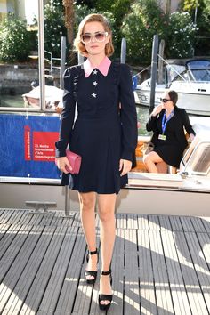 a woman standing on top of a wooden dock