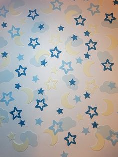 stars and moon stickers are on the wall in front of a white background with blue clouds