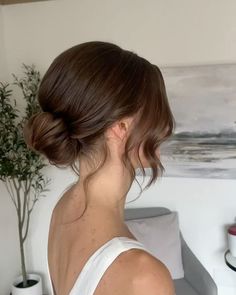 a woman with her hair in a low bun