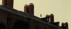 two tall brick buildings with clocks on them