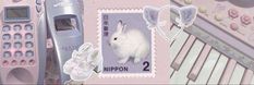 a postage stamp with a rabbit on it next to a cell phone, keyboard and other items