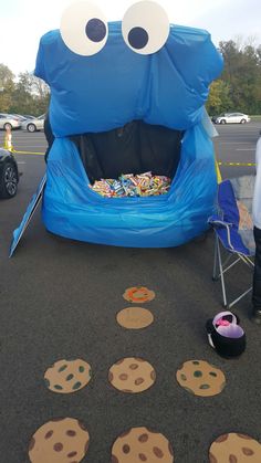 an inflatable chair with cookies on the ground next to it and two eyes