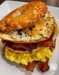 a breakfast sandwich with eggs, bacon and cheese