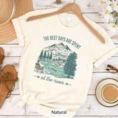 The Best Days Are Spent at the River T-Shirt. Looking for a unique graphic tee to wear while spending summer vacation days at the river? This vintage-style tshirt with peaceful stream flowing through mountain scenery will be sure to please anyone who loves camping, boating and fishing at the river!  HOW TO ORDER 1) Choose the shirt size you'd like in the 1st drop down menu. See below for help with Sizing & Fit. 2) Select the shirt color you prefer in the 2nd drop down menu.  PRODUCT FEATURES & S Lake Shirts, River Outfit, Growing Rosemary, Tee Ideas, Camp Shirts, T-shirt Print Design, River Life, Camping Tee, Style Tshirt