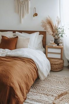 a bed with brown sheets and pillows in a bedroom