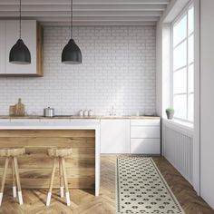 a kitchen with white brick walls and wooden flooring, two stools in front of the counter