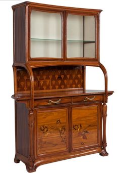 an old fashioned wooden china cabinet with glass doors on the top and bottom shelf,