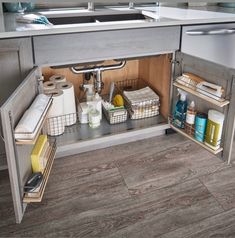 an open cabinet in the middle of a kitchen