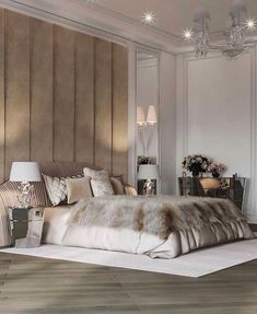 a bedroom with white walls and wood flooring is pictured in this image, there are two lamps on either side of the bed