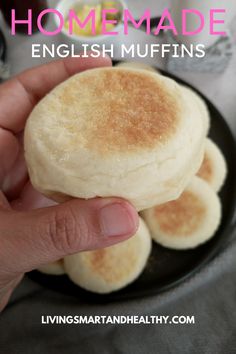 a hand is holding some english muffins on a plate with the words, homemade english muffins