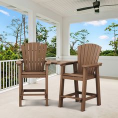 two wooden chairs sitting on top of a patio