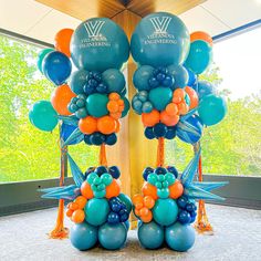 balloons are arranged in the shape of birds and flowers on display at a corporate event