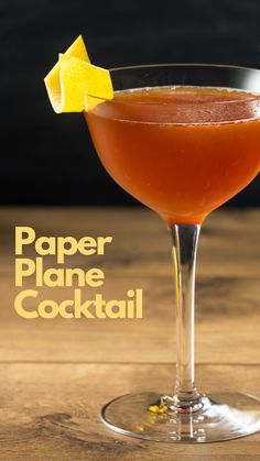 a cocktail in a coupe glass with a lemon wedge on the rim and text paper plane cocktail