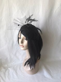 HatsByJosie: This black feathered fascinator hat is ideal for wedding, mother of the bride, women church hat, Kentucky Derby hat, tea Party hat or any other special occasion. Easy to wear Can be worn on both sides Floaty feathers Dotted floaty veil Free standard shipping Shipping upgrades available: Priority shipping 2-3 business days Express shipping 1-2 business days Love what you see would like a different color? Please feel free to send a message we'd love to create a hat for you. Looking fo Black Gatsby Fascinator For Parties, Gatsby Style Black Fascinator For Parties, Black Gatsby Style Fascinator For Party, Black Gatsby Style Party Fascinator, Black Gatsby Fascinator For Evening, Black Gatsby Style Fascinator For Evening, Elegant Halloween Fascinator, Black Hat-style Headpieces For Wedding, Black Hat Headpiece For Wedding