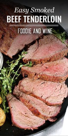 sliced beef tenderloin on a plate with potatoes and herbs