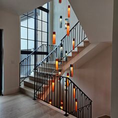 a staircase with many lit candles on the railing and handrails in front of it