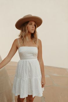 Our Seraphina Dress features an airy cotton fabric perfect for spring + summer. With embroidered eyelet detail throughout, dainty spaghetti straps and a tie back for a customizable fit. Pair it with some gold accessories and strappy sandals or wedges for an easy day or night look! Care + Measurements: 100% cotton Fully lined Hand wash cold S: approx 34.5" L (measured from shoulder to hem of skirt) Summer Dress With Delicate Straps For Garden Party, Chic Summer Dresses With Removable Straps, Summer Cotton Dresses With Delicate Straps, Summer Sundress With Delicate Straps, Spring Vacation Dress With Delicate Straps, Summer Dresses With Delicate Straps For Day Out, Spring Brunch Sundress With Delicate Straps, Spring Cotton Dresses With Delicate Straps, White Breezy Dress With Adjustable Straps