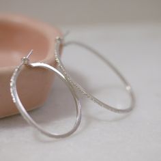 The Diamond Dusted Oval Hoops are a fun pop of sparkle that adds effortless glamour to any outfit. This is our best-selling diamond dusted hoops in a NEW shape. Available in two sizes. details+ small hoop measures approx. 1 1/4" in diameter+ medium hoop measures approx. 1 3/4" in diameter+ handmade with love in our Georgia studio availability handmade to order. ships in 5 - 14 days.current production timeline pressed for time? select the rush your order option to have your item made in 1 - 2 bus Hoop Jewelry With Glitter For Gifts, Glitter Hoop Earrings Gift, Sparkling Small Hoop Sterling Silver Earrings, Sparkling Sterling Silver Hoop Jewelry, Sparkling Hoop Earrings For Everyday, Everyday Sparkling Hoop Earrings, Oval Hoop Earrings, Dust Collection, Gold Vermeil