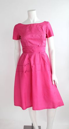 "Gorgeous vintage party dress from the 1950s by Emma Domb. Features a banded waist with petite bows, darted bust, and full circle skirt. Closure is at center back with perfectly functioning metal zipper. Constructed of bright pink nylon taffeta. The perfect dress for summer parties or weddings!  DETAILS Condition: Excellent! This dress has been very well cared for with minimal signs of wear.   Label + Era: Emma Domb; 1950s Fabrication: Nylon taffeta  Color: Bright Pink Marked size: n/a Fits like Emma Domb, Vintage Party Dress, Vintage Party Dresses, Full Circle Skirt, Dress For Summer, 1940s Dresses, Full Circle Skirts, Vintage Party, Summer Parties