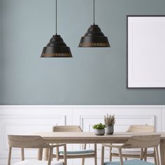 a dining room table and chairs with two pendant lights above it, in front of a blue wall