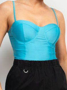 Sweetheart Corset-Like Cami Top Brand: Haute Monde Style: HMT56857 Fabric: 88% POLYESTER, 12% SPANDEX Details: A knit casual glamour top in solid color features a bustier corset-like bodice, sweetheart neckline, adjustable cami straps, and cropped length. Iris Tops Made in Cambodia. Fitted Seamless Blue Top, Trendy Solid Tops With Lined Body, Light Blue Fitted Seamless Crop Top, Fitted Light Blue Seamless Crop Top, Fitted Seamless Light Blue Crop Top, Trendy Party Camisole In Solid Color, Trendy Camisole For Party, Bra Friendly Cami Top For Party, Bra-friendly Cami Top For Party