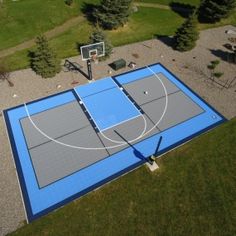 an aerial view of a basketball court in the middle of a park