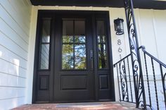 a black front door on a white house