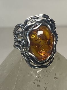 "Amber ring Israel by PZ boho sterling silver women girls Size 9.75 Weight 10.3g Length 1. 1/8\" Width 3/4\" Thinnest part of band 1/4\" Free Shipping & Free Postal Insurance Delivered in a Gift Box If you do not want the ring polished and want to leave the natural patina please let me know at the time of purchase as I do polish rings before I ship rings out. Thanks Free First Class shipping and postal insurance is included. If you want to upgrade to priority kindly pay an additional fee to do s Amber Rings, Mickey Mouse Ring, Starfish Ring, Spiral Shell, Amber Ring, Everyday Rings, Amber Jewelry, Wide Bands, Piercing Jewelry