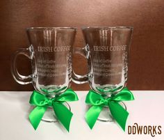 two glass coffee mugs with green bows on the front and back, one is for irish coffee