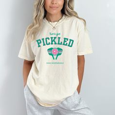 a woman wearing a pickled t - shirt and sweatpants