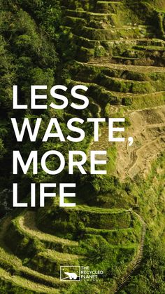 the words less waste, more life are shown in white letters on a green hillside