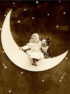 a baby sitting on the moon with a dog