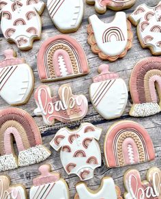 decorated cookies with pink and white frosting on a wooden table next to each other