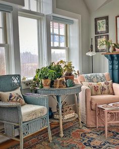 a living room filled with furniture next to two windows and a fire place in the corner