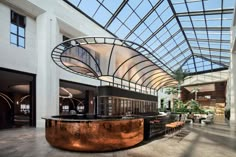 the inside of a building with tables and chairs