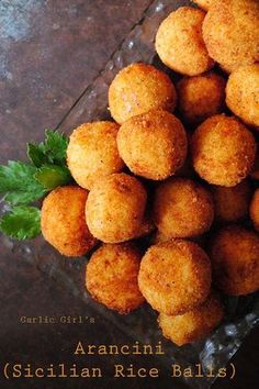 there is a pile of fried food on the table with words above it that read, ancient sicilian rice balls