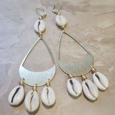 Beach Drop Earrings In Metal, Metal Drop Earrings For Beach, Beach Dangle Chandelier Earrings, Bohemian Nickel-free Earrings For Vacation, Beach Metal Drop Earrings, Gold Metal Hoop Earrings For Beach, Bohemian Cowrie Shell Dangle Jewelry, Bohemian Dangle Teardrop Earrings For The Beach, Elegant Nickel-free Hoop Earrings For Beach