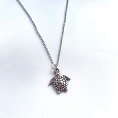 Lovely, dainty turtle necklace in silver 🐢  Good quality silver for long lasting wear.  Perfect for any turtle lovers!  For gifts, a personal message can be included in the order to give them an extra smile. Turtle charm measures: 1.6cm x 1.4cm.   Adjustable length - chain approximately 40cm. Lightweight and comfortable to wear. Eco friendly and/or Recycled packaging ♻️  Thank you for checking out my shop, Charlotte <3 Female owned shop 🤍👑 UK owned shop 🇬🇧  ---------------------- Check out my Instagram:  https://www.Instagram.com/CosyClayCreations  You can also join my mailing list for discounts and updates on new releases! Send me an email saying 'mailing list' to be added to the mailing list. (CosyClayCreations@gmail.com) Beach Jewellery, Turtle Charm, Turtle Necklace, Jewellery Gifts, Mailing List, Handmade Boho, Boho Beach, Recycled Packaging, Beach Jewelry