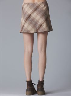 New colorway! Plaid, mini wrap-skirt with branded button at the waist. Model is 5'11" and wearing a size S. 50% Nylon, 50% Polyester Imported SKU: UWSK-1091 Mini Wrap Skirt, Brown Plaid, Secret Sale, Platform Boots, Wrap Skirt, New Shop, Sweater Jacket, Womens Bottoms, Womens Skirt