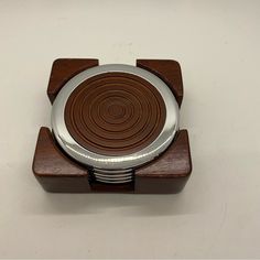 a wooden and metal object on a white surface