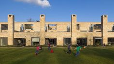 children playing in front of a large brick building