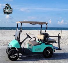 a blue golf cart parked on the beach