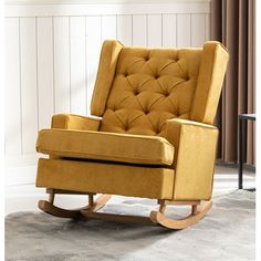 a yellow rocking chair sitting on top of a carpeted floor